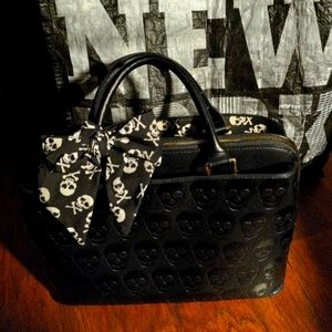 Betsey Johnson Satchel. Color Black with skull embellishments and shoulder strap